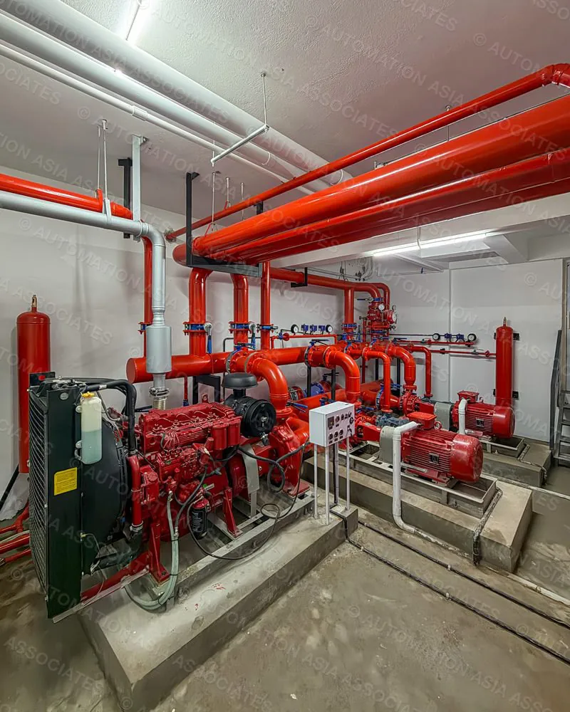 Fire pump room with diesel engine pump, electric pumps and red header pipework